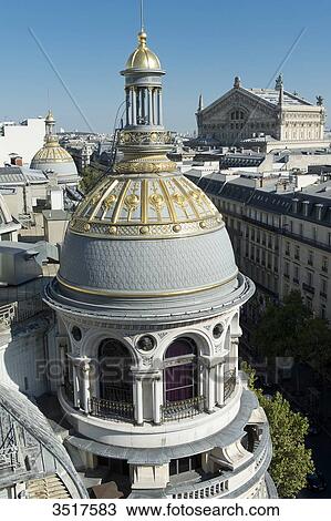 Stock Image - France. Paris 9th district. Turret of the department store Au Printemps. Far off: the Garnier Opera. Fotosearch