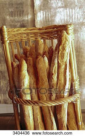 Stock Photograph - France, Paris, bakery, freshly baked French baguettes in a basket. Fotosearch
