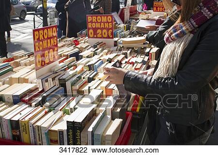 Stock Image - France, Paris, Boulevard Saint-Michel, special offers on books, stalls on the sidewalk. Fotosearch