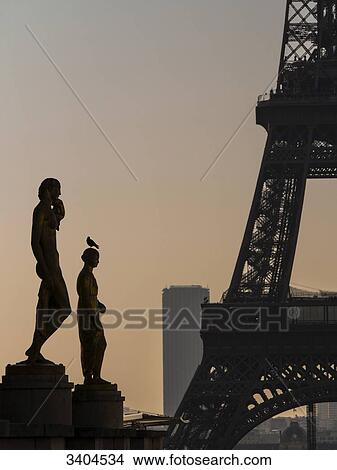 France, Paris, two colored bronze statues (1937) on the Trocadro esplanade with the Eiffel Tower and the Montparnasse Tower in the twilight View Large Photo Image Picture - France, Paris, two colored bronze statues (1937) on the Trocadro esplanade with the Eiffel Tower and the Montparnasse Tower in the twilight. Fotosearch