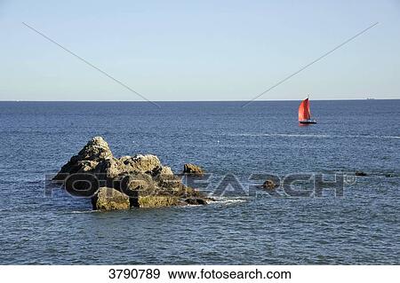 Stock Photo - France, Pays de la Loire region, Loire-Atlantique department, small ship cruising off the wild coast at Le Pouliguen on Atlantic coast.. Fotosearch