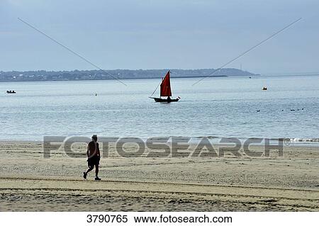 Stock Photography - France, Pays de la Loire region, Loire-Atlantique department, beach and ship cruising in bay of La Baule, Pornichet in the background.. Fotosearch