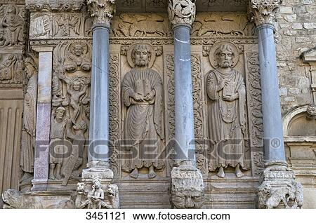 Stock Image - France, South-Eastern France, Arles, Church of Saint Trophime, sculpted portal, martyrdom of St Stephen, St James the Greater and St Philip. Fotosearch