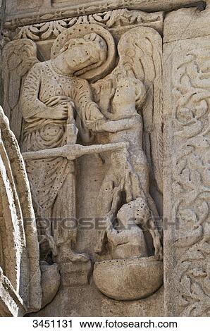 Stock Image - France, South-Eastern France, Arles, Church of Saint Trophime, sculpted Romanesque southern portal, St Michael. Fotosearch