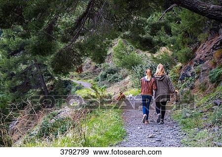 Stock Photo - France, Var, Mother and daughter walking view from the back. Fotosearch