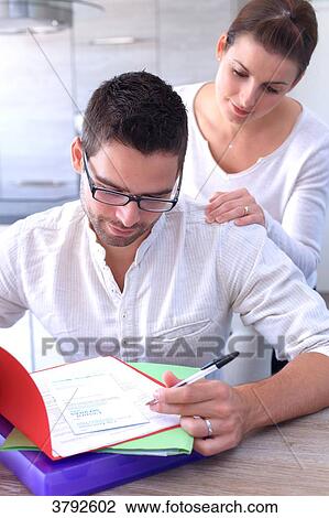 France, young couple in their new house looking at forms. View Large Photo Image Stock Image - France, young couple in their new house looking at forms.. Fotosearch