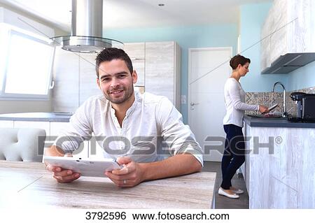 Stock Photograph - France, young couple in their new house.. Fotosearch