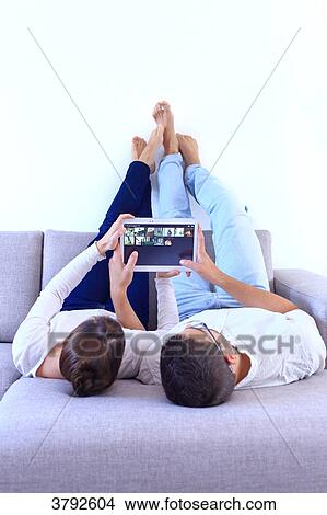 France, young couple looking at their tablet. View Large Photo Image Picture - France, young couple looking at their tablet.. Fotosearch