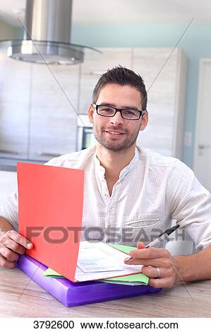 France, young man looking at forms. View Large Photo Image Stock Image - France, young man looking at forms.. Fotosearch