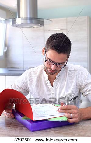 France, young man looking at forms. View Large Photo Image Stock Image - France, young man looking at forms.. Fotosearch