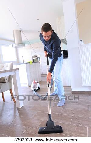 France, young man using vacuum cleaner. View Large Photo Image Stock Image - France, young man using vacuum cleaner.. Fotosearch