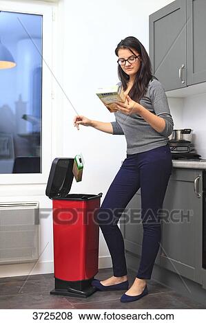 Stock Photo - France, young woman at home.. Fotosearch