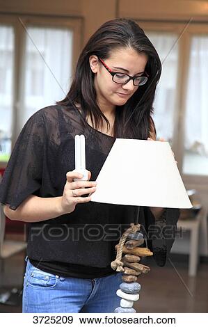 Stock Photo - France, young woman at home.. Fotosearch