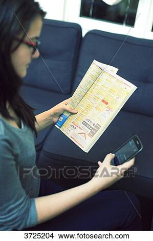 France, young woman at home using french yellow pages. View Large Photo Image Picture - France, young woman at home using french yellow pages.. Fotosearch