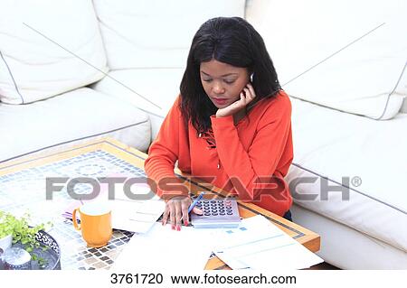 France, young woman at home, with invoices. View Large Photo Image Stock Image - France, young woman at home, with invoices.. Fotosearch