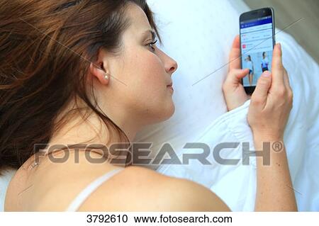 France. Young woman using smartphone by night. View Large Photo Image Stock Image - France. Young woman using smartphone by night.. Fotosearch