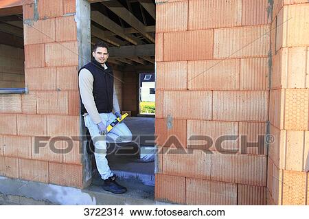 France, young working person in a house in construction. View Large Photo Image Picture - France, young working person in a house in construction.. Fotosearch