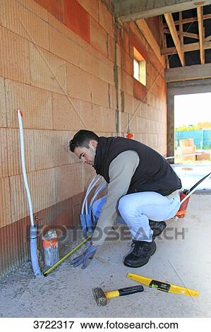 France, young working person in a house in construction. View Large Photo Image Stock Photo - France, young working person in a house in construction.. Fotosearch