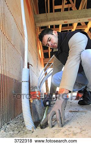 France, young working person in a house in construction. View Large Photo Image Stock Photo - France, young working person in a house in construction.. Fotosearch