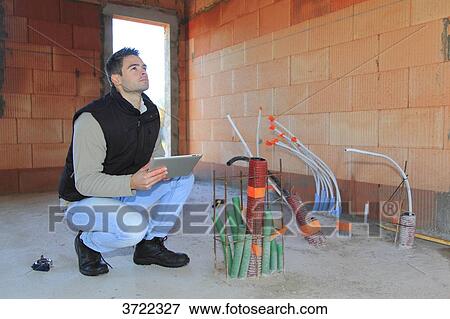 France, young working person in a house in construction. View Large Photo Image Stock Photo - France, young working person in a house in construction.. Fotosearch