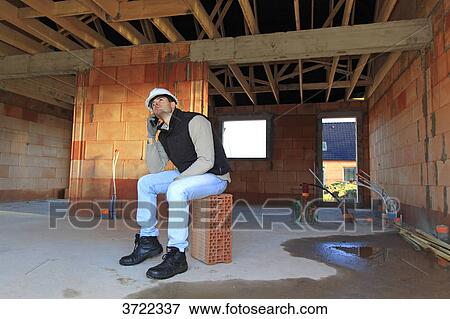 France, young working person in a house in construction. View Large Photo Image Stock Photo - France, young working person in a house in construction.. Fotosearch