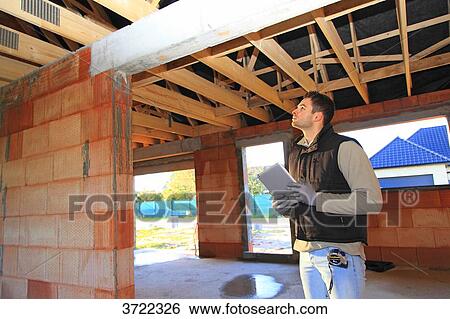 France, young working person in a house in construction. View Large Photo Image Stock Photograph - France, young working person in a house in construction.. Fotosearch