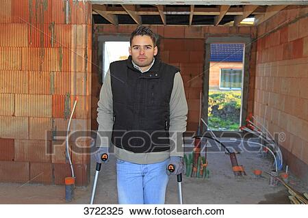 France, young working person with crutches in a house in construction. View Large Photo Image Stock Photography - France, young working person with crutches in a house in construction.. Fotosearch