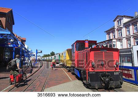 Germany, Lower Saxony. Borkum Island. Railway station, platform and travelers in the middle of the city center View Large Photo Image Stock Image - Germany, Lower Saxony. Borkum Island. Railway station, platform and travelers in the middle of the city center. Fotosearch