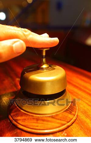 Hand pressing hotel bell. View Large Photo Image Stock Photo - Hand pressing hotel bell.. Fotosearch