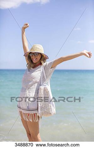 Happy blonde woman arriving at the beach View Large Photo Image Stock Image - Happy blonde woman arriving at the beach. Fotosearch