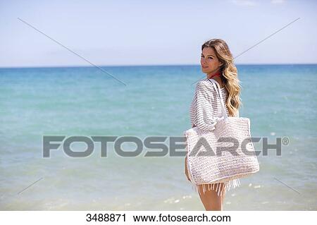 Happy blonde woman arriving at the beach View Large Photo Image Stock Image - Happy blonde woman arriving at the beach. Fotosearch