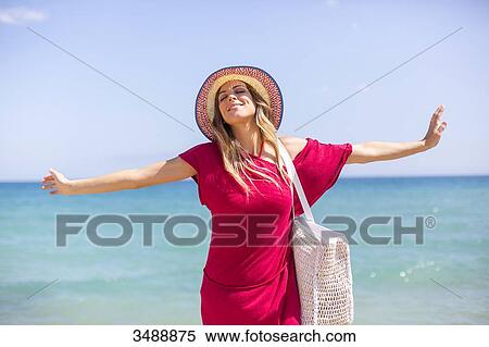Happy blonde woman arriving at the beach View Large Photo Image Stock Photography - Happy blonde woman arriving at the beach. Fotosearch