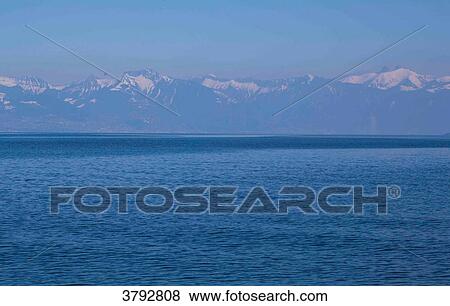 Lake Geneva, and mountain in the back ground View Large Photo Image Stock Photo - Lake Geneva, and mountain in the back ground. Fotosearch
