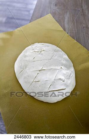 Loaf of bread ready to bake on a baking paper View Large Photo Image Stock Image - Loaf of bread ready to bake on a baking paper. Fotosearch