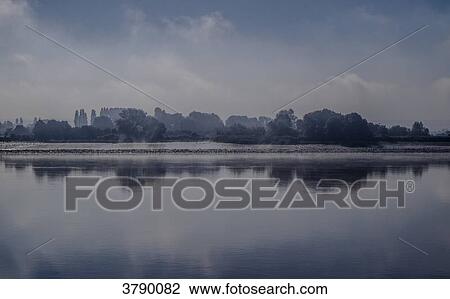 Stock Image - Morning light in Normandie's Seine river banks. Fotosearch
