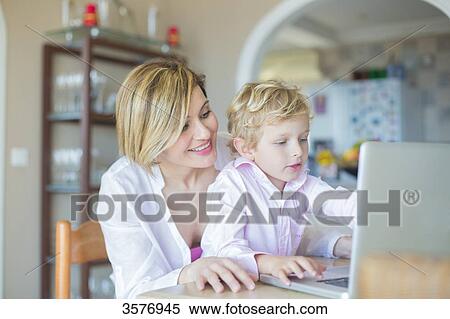 Mother and son with laptop at home View Large Photo Image Stock Photography - Mother and son with laptop at home. Fotosearch