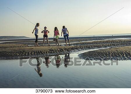 Normandy, Four kids playing on the beach View Large Photo Image Stock Image - Normandy, Four kids playing on the beach. Fotosearch