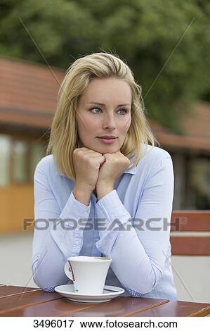 Pensive blonde woman in a Cafe View Large Photo Image Stock Photo - Pensive blonde woman in a Cafe. Fotosearch