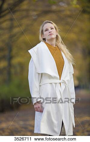 Pensive pretty blonde woman with coat in Park in Autumn View Large Photo Image Stock Image - Pensive pretty blonde woman with coat in Park in Autumn. Fotosearch