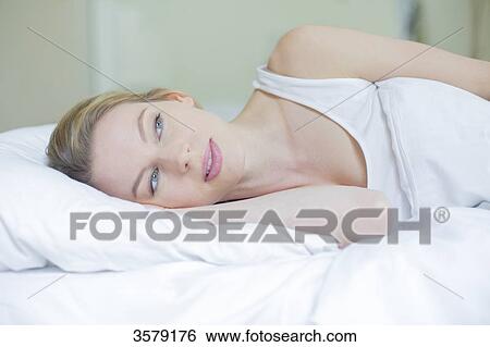 Pensive pretty woman in bed View Large Photo Image Stock Photograph - Pensive pretty woman in bed. Fotosearch