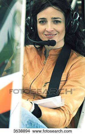 Pilot young woman in the cockpit of her microlight. View Large Photo Image Picture - Pilot young woman in the cockpit of her microlight.. Fotosearch