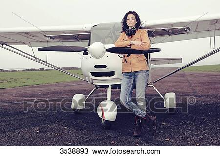 Pilot young woman standing in front of her microlight. View Large Photo Image Stock Image - Pilot young woman standing in front of her microlight.. Fotosearch