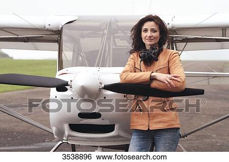 Pilot young woman standing in front of her microlight. View Large Photo Image Stock Photograph - Pilot young woman standing in front of her microlight.. Fotosearch