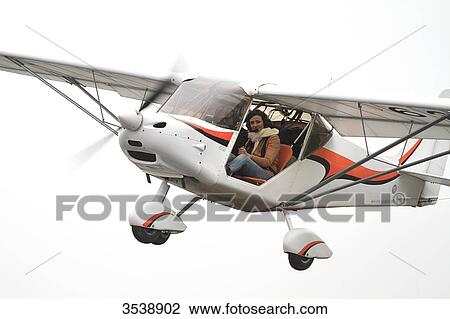 Pilot young woman taking off on board of a microlight. View Large Photo Image Stock Image - Pilot young woman taking off on board of a microlight.. Fotosearch