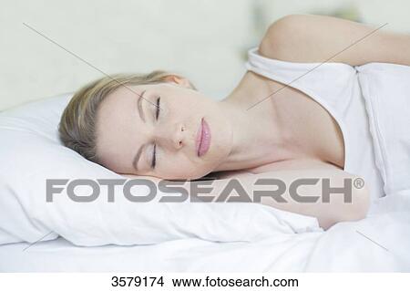 Portrait of a beautiful woman sleeping in bed View Large Photo Image Picture - Portrait of a beautiful woman sleeping in bed. Fotosearch