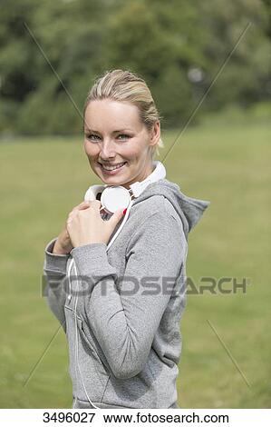 Portrait of a blonde woman doing sport in the park with headphones View Large Photo Image Stock Photo - Portrait of a blonde woman doing sport in the park with headphones. Fotosearch