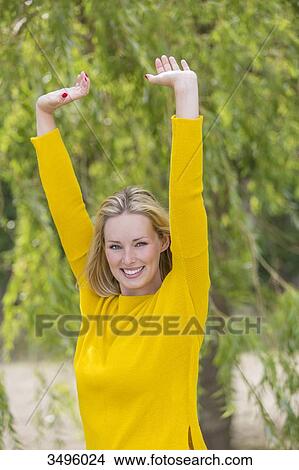 Portrait of a blonde woman in park smiling at camera View Large Photo Image Picture - Portrait of a blonde woman in park smiling at camera. Fotosearch