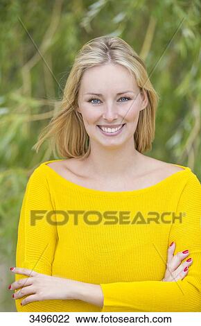 Portrait of a blonde woman in park smiling at camera View Large Photo Image Stock Image - Portrait of a blonde woman in park smiling at camera. Fotosearch