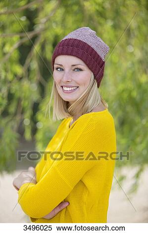 Portrait of a blonde woman in park smiling at camera View Large Photo Image Stock Photography - Portrait of a blonde woman in park smiling at camera. Fotosearch