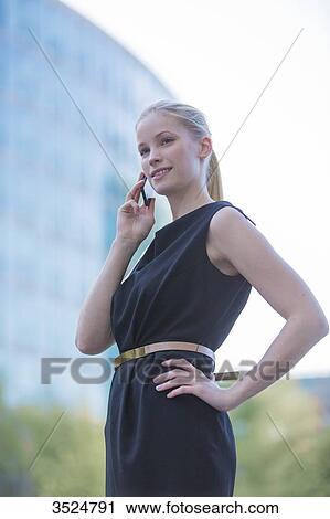 Portrait of a business woman with mobile in front of an office building View Large Photo Image Stock Image - Portrait of a business woman with mobile in front of an office building. Fotosearch